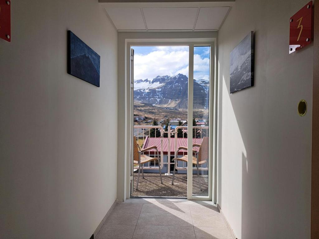 a hallway with a window with a view of a mountain at The Old Post Office Guesthouse in Grundarfjordur