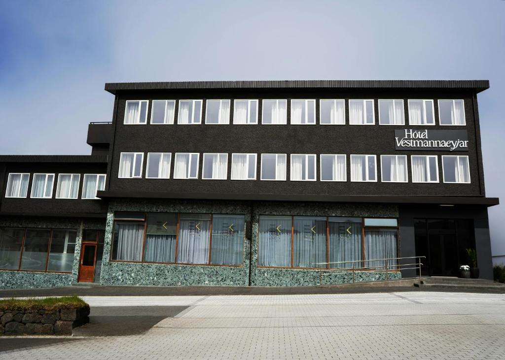 a black building with a sign on the front of it at Hotel Vestmannaeyjar in Vestmannaeyjar