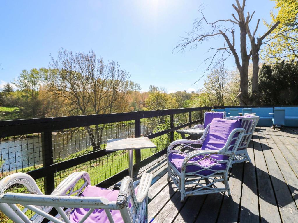 two chairs and a table on a deck at Apartment 2 in Aberdeen