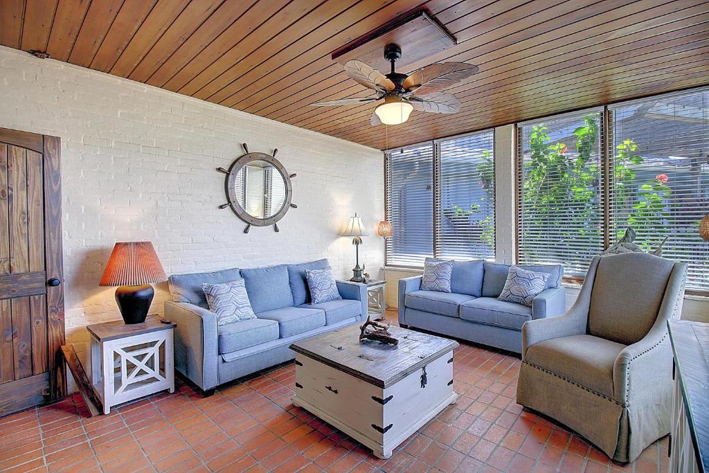 a living room with two blue couches and a table at Beachhead Unit 5 BH5 in Port Aransas