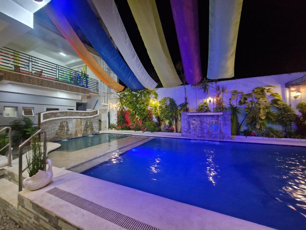 a large swimming pool in a building at Aquatico Royalle Private Resort in Calamba