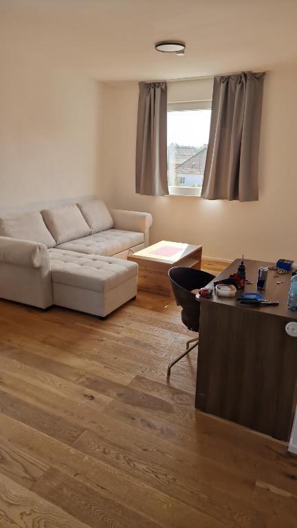 a living room with a couch and a table at S3 Stadl Paura in Stadl-Paura