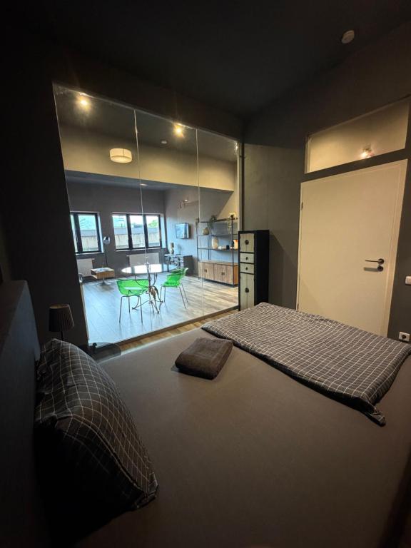 a bedroom with a large bed and a living room at Smartstay Porta in Porta Westfalica