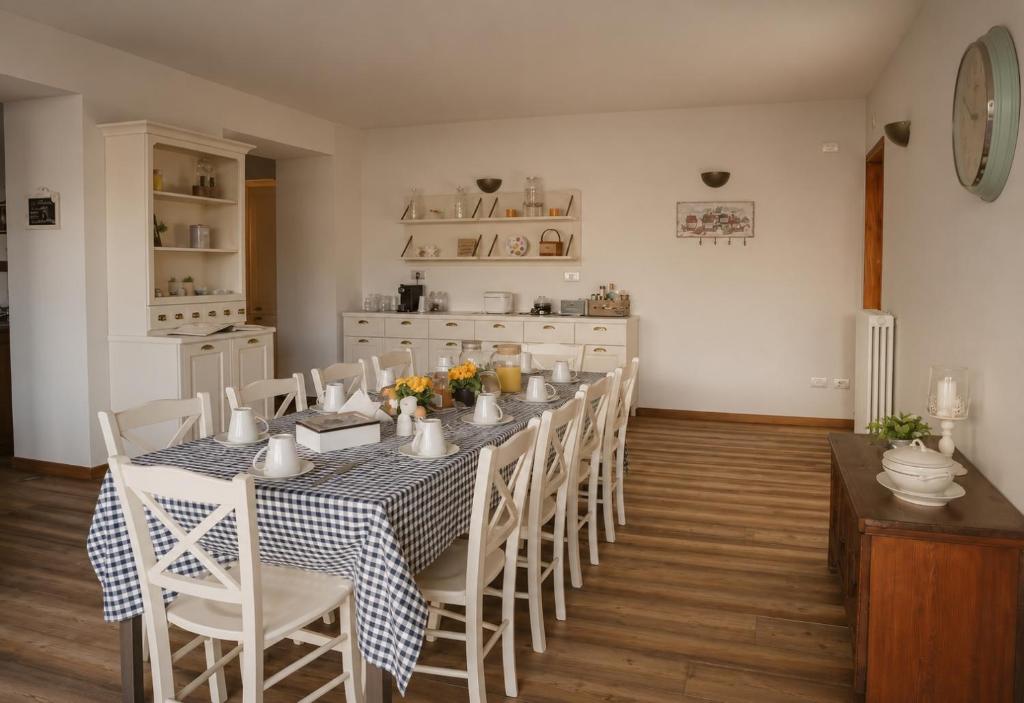a dining room with a long table and chairs at La Corte di Nonna Gemma - Holiday Home in Delebio