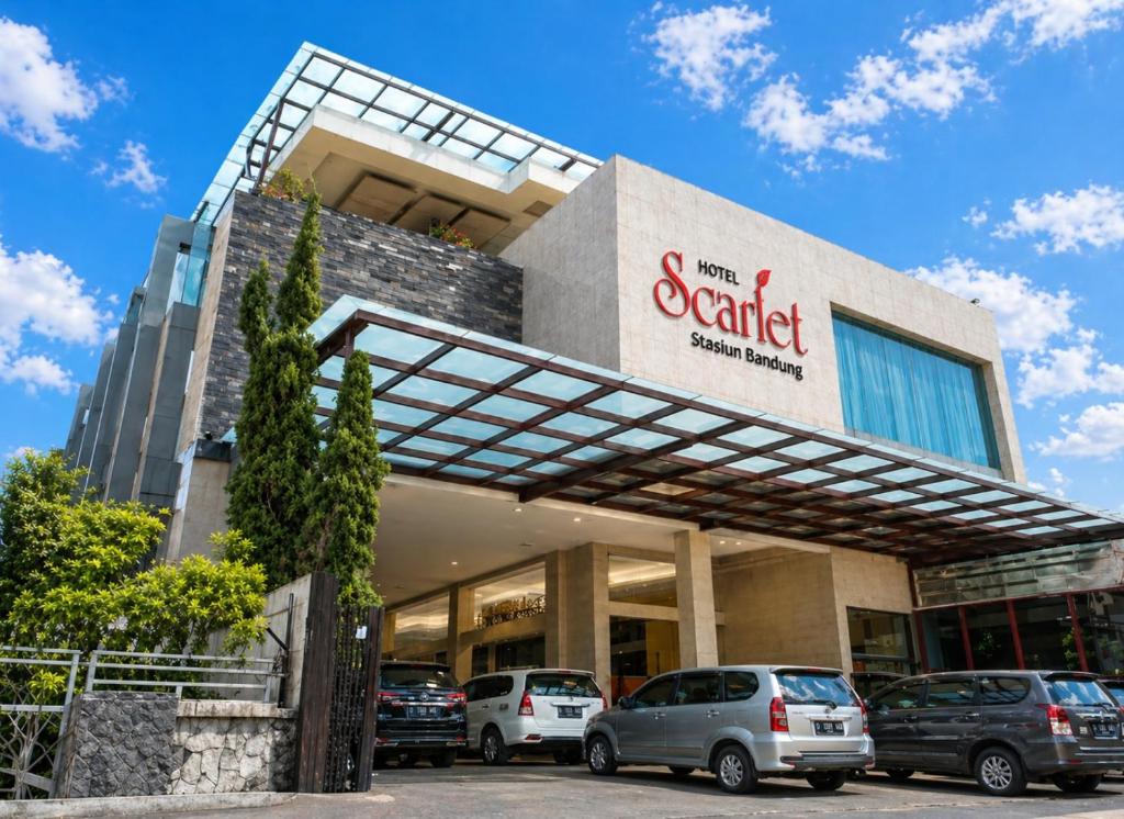 a car dealership with cars parked in front of it at Scarlet Hotel Stasiun Bandung in Bandung