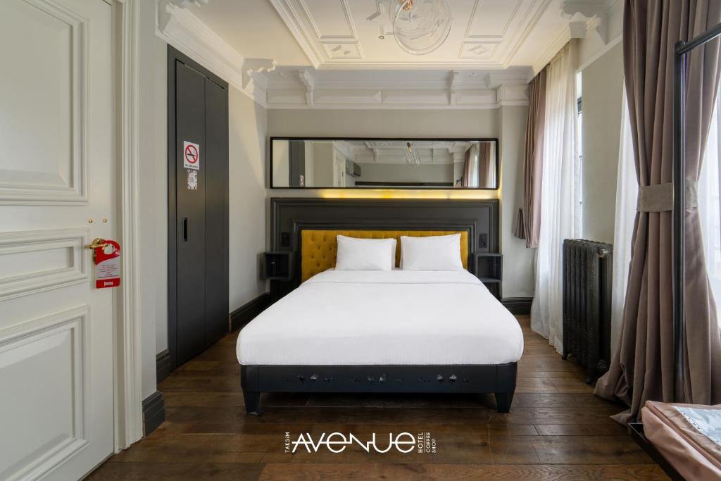 a bedroom with a white bed in a room at Taksim Avenue in Istanbul