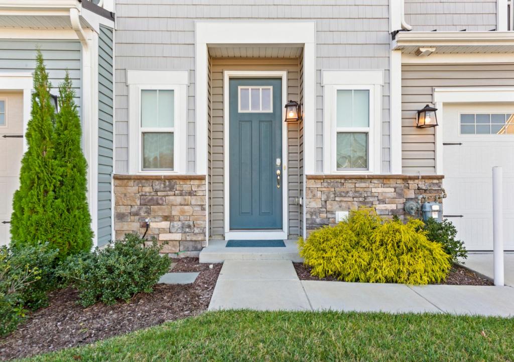 a front door of a house with a blue door at Modern Townhouse with Pool Gym & Tennis Near Beach in Ocean View