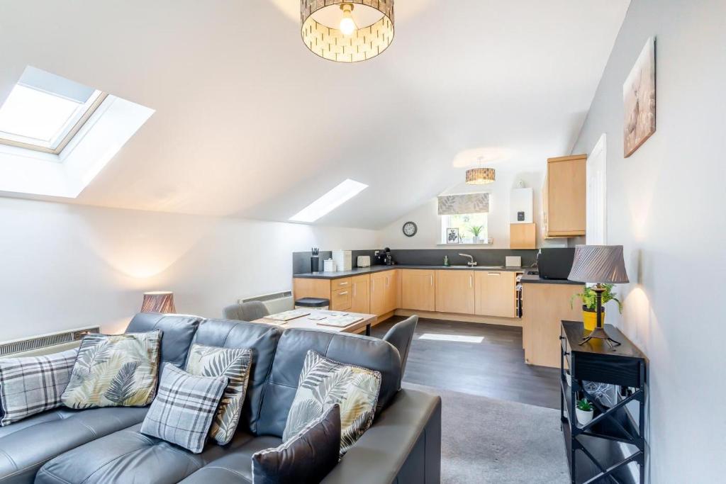 a living room with a couch and a kitchen at 1 Bed in Holmfirth oc-88554 in Holmfirth