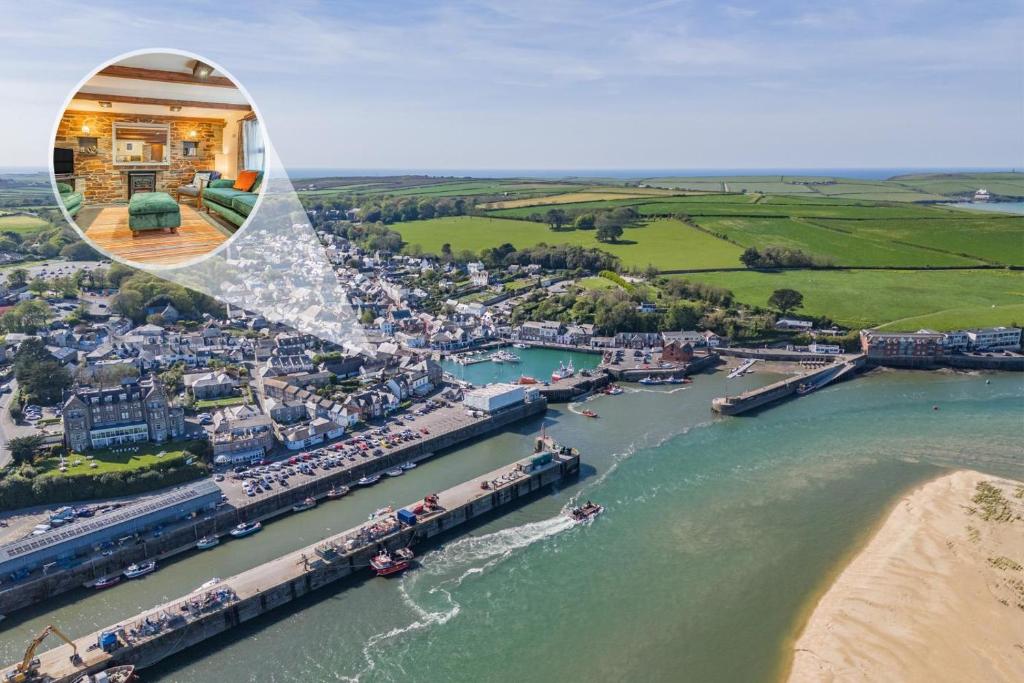 an aerial view of a city with a train on a river at 3 Bed in Padstow oc-h28928 in Padstow