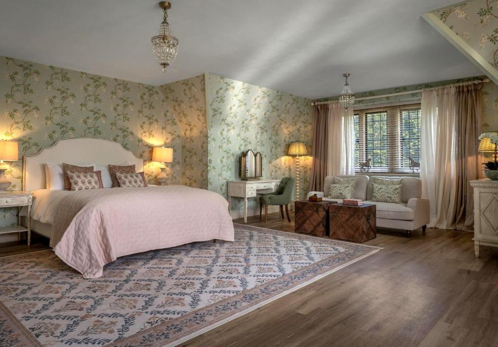 a bedroom with a bed and a desk and a chair at Whistler Rooms in Peterborough