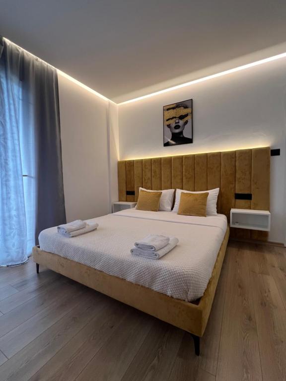 a bedroom with a large bed with towels on it at Vila Mario in Ksamil