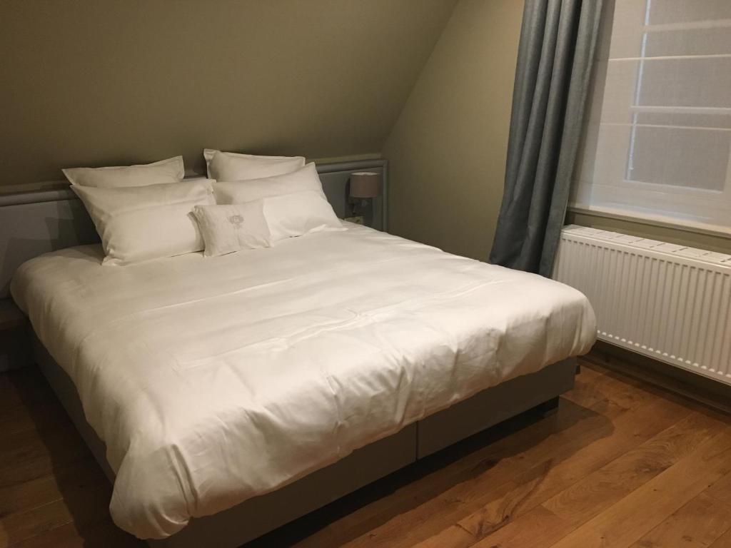 Postel nebo postele na pokoji v ubytování De Gouden Klokke