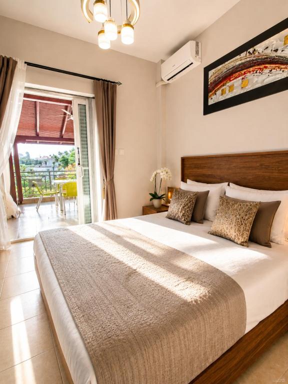 a bedroom with a large bed and a balcony at Flogita 5 Seaside Apartments - 150m from Beach, Ideal for Families & Groups in Flogita
