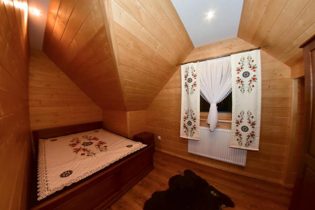 Postel nebo postele na pokoji v ubytování Domek w Ogrodzie