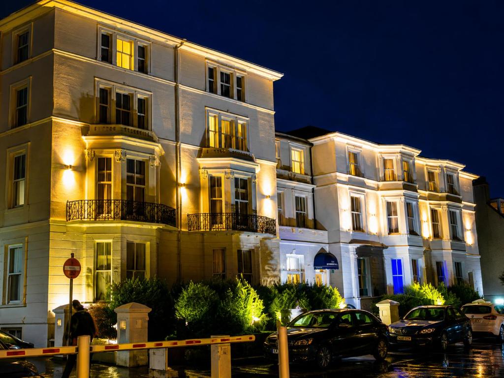 a large white building with cars parked in front of it at The Carlton Hotel in Folkestone