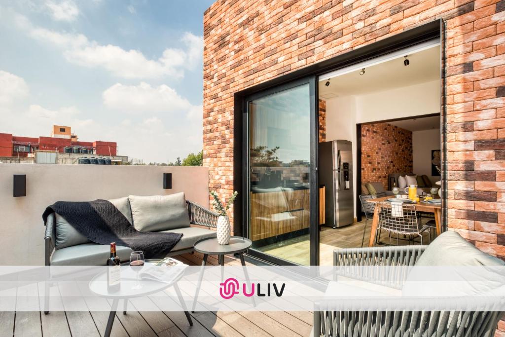 a balcony with a view of a brick building at ULIV Roma Norte in Mexico City