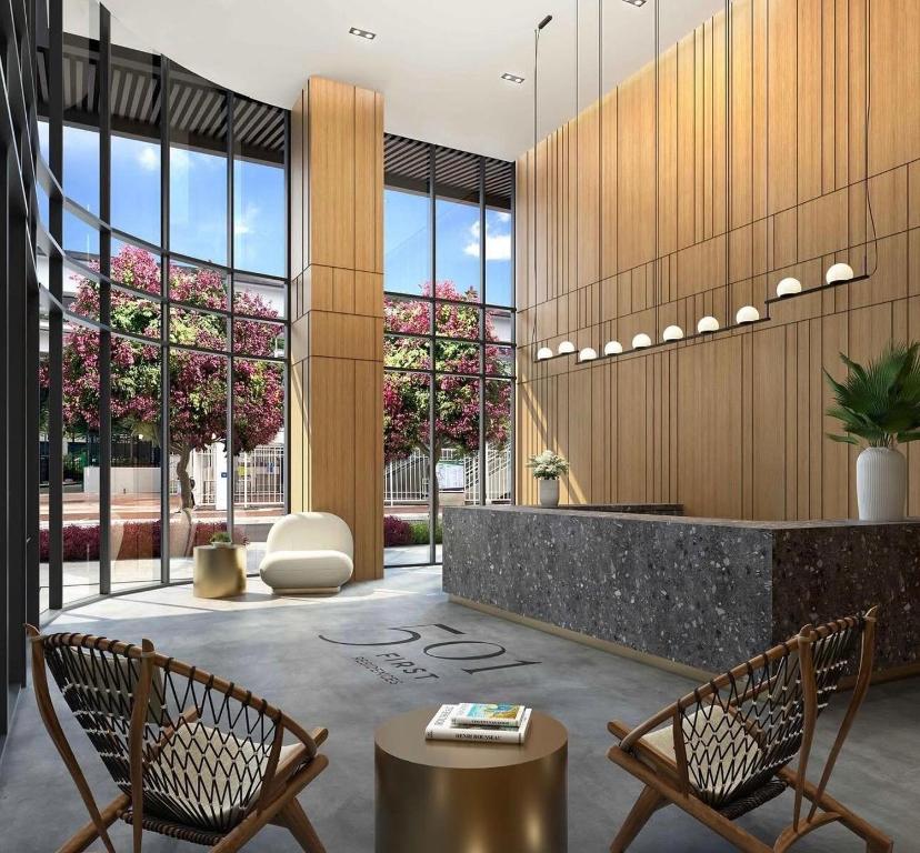 a lobby with two chairs and a table at 501 First Residences by Palermo Home Miami in Miami