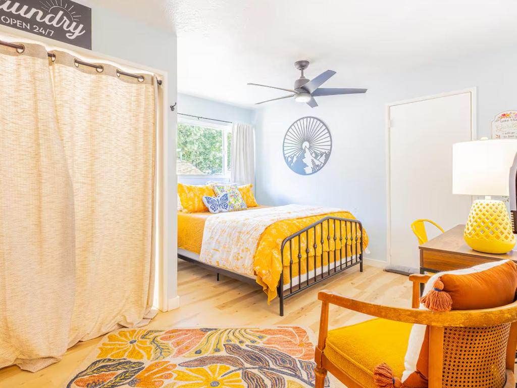 a bedroom with a bed and a chair and a window at Sunshine Loft in Wrightwood