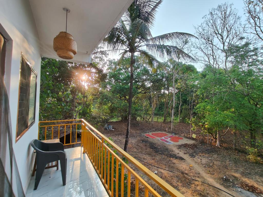 a balcony with a view of the forest at The Long Stay Goa in Arambol
