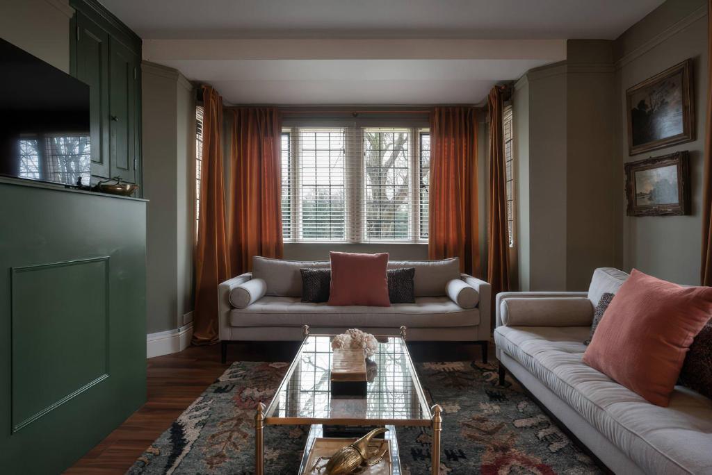 a living room with two couches and a table at The Gatehouse in Peterborough