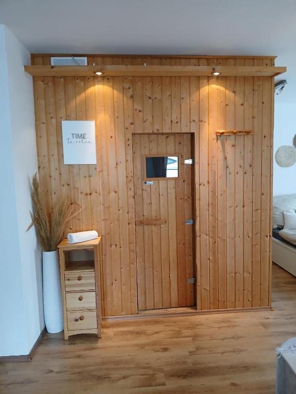 a wooden door in a room with a bed at Wohlfühloase mit Sauna in Mayen
