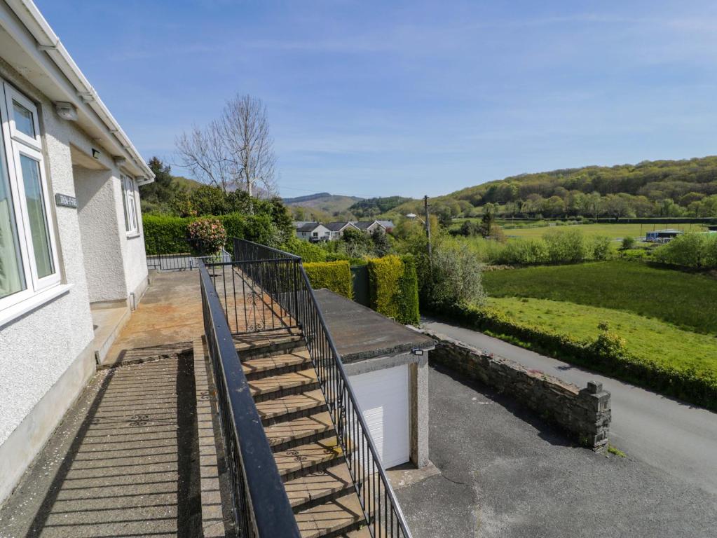 a balcony of a house with a view of a field at Trem Y Foel in Penrhyndeudreath