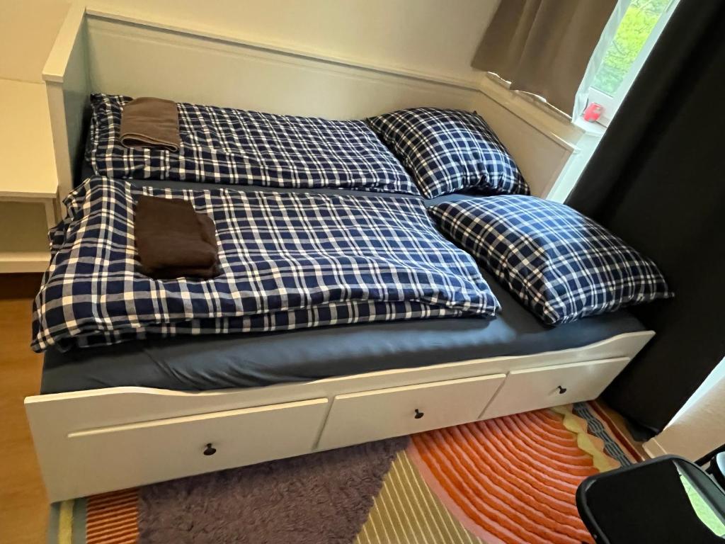 a bed with four pillows sitting on top of it at Private Room in Oldenburg with Balcony in Shared Apartment in Hundsmühlerhöhe