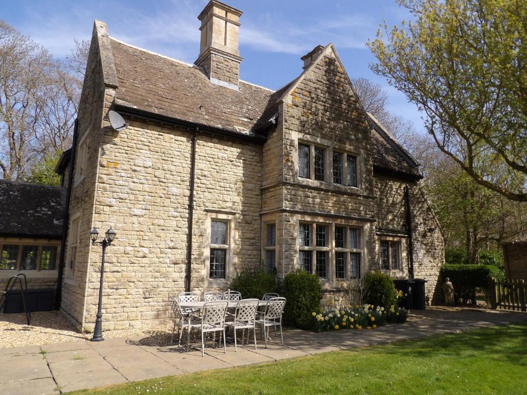 an old stone building with chairs in front of it at Greenwood Manor in Peterborough
