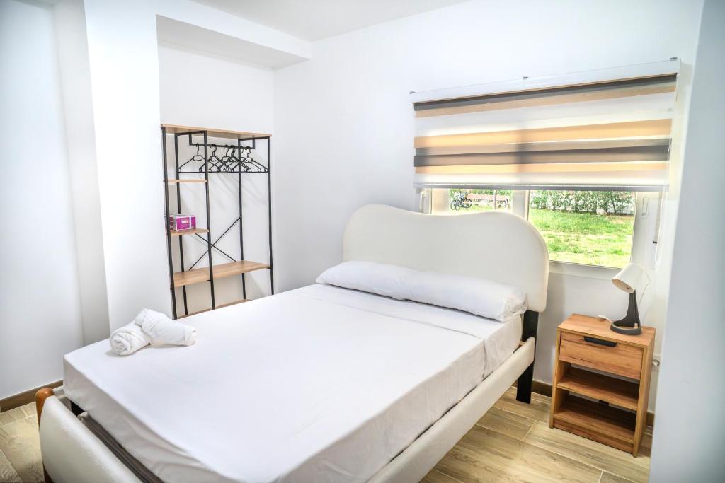 a bedroom with two beds and a window at Hostale Blas Cabrera Madrid in Madrid