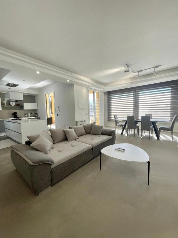 a living room with a couch and a table at Deluxe Appartment in Cinisi