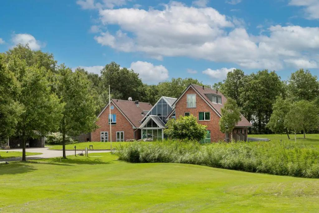 a large brick house with a green yard at Cozmoss Boutique Hotel in Erica