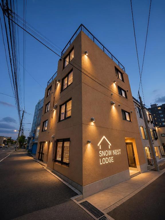 a building with a sign on the side of it at Snow Nest Lodge in Sapporo