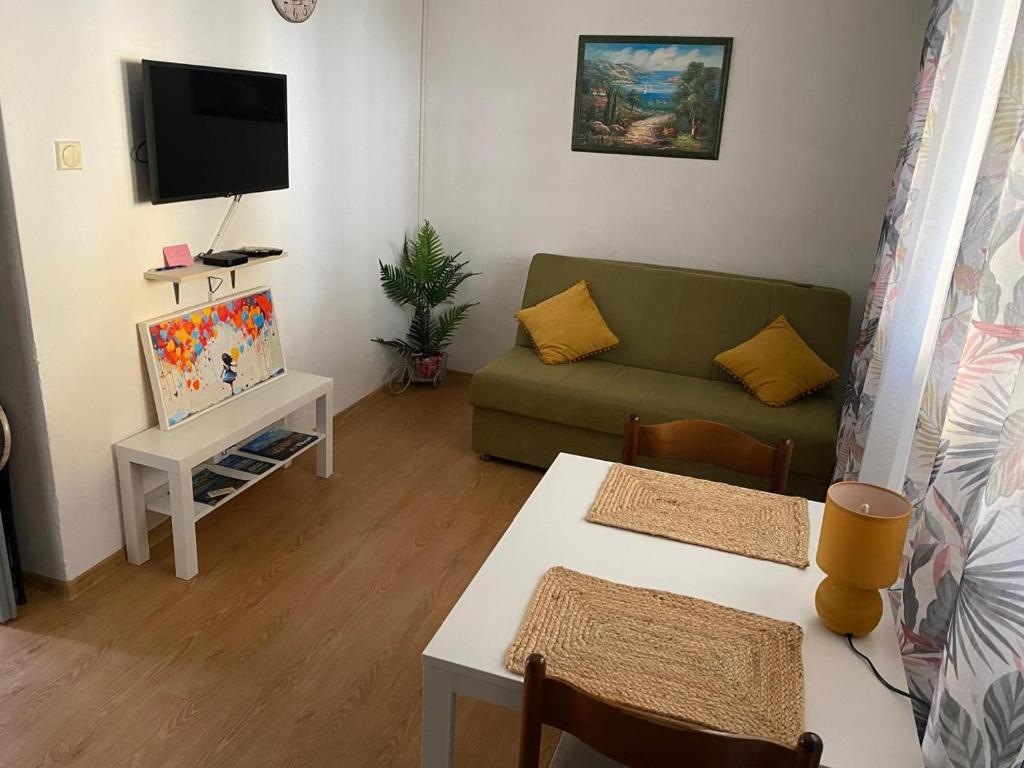 a living room with a couch and a table at Sun Apartment in Tivat