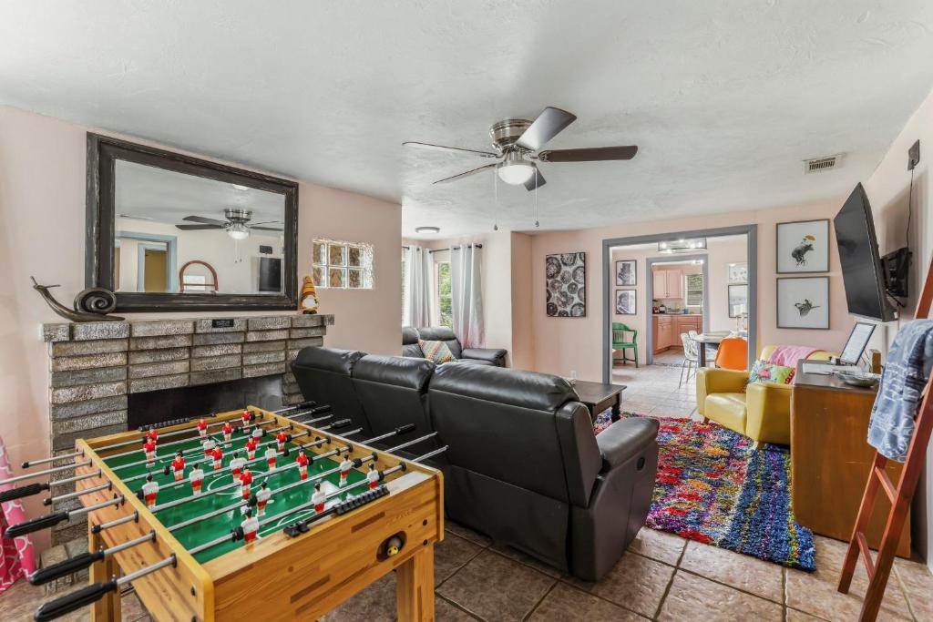 a living room with a foosball table at Bright 3BR, Dogs, Fenced Yard, FSU & Dwntown in Tallahassee
