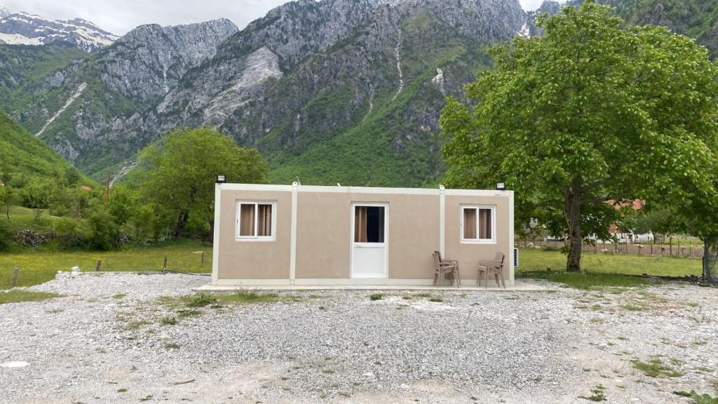a small house in front of a mountain at David's House in Ndërlysaj