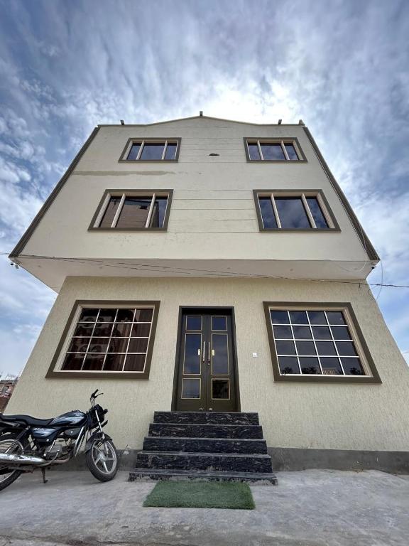a house with a motorcycle parked in front of it at Hotel LD Empire in Amritsar