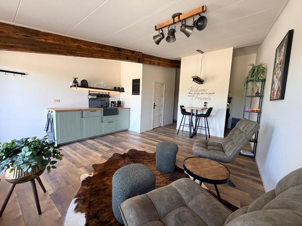 a living room with a couch and chairs and a table at B&B Goeje Morge in Ammerzoden
