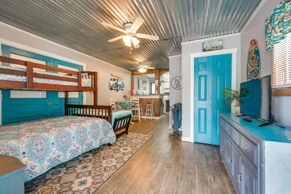 a bedroom with a bed and a tv and a ceiling at 1 Mi to Ocean Isle Beach! Studio w/ Outdoor Oasis in Ocean Isle Beach