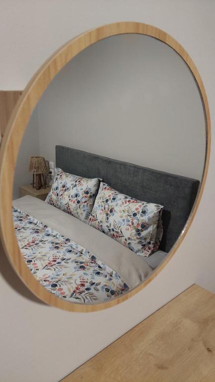 a mirror above a bed with pillows on it at Family House Kat in Ioannina