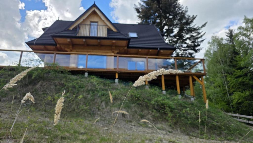 a house on top of a hill with glass at Sarnia CHATA in Brenna