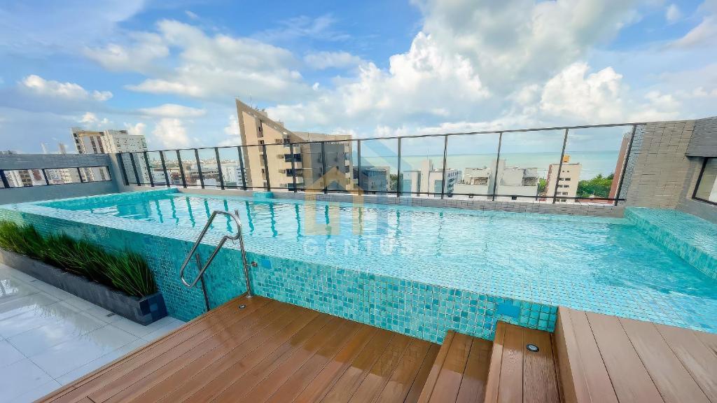 a swimming pool on the roof of a building at Unigreen Manaíra Genius Flats in João Pessoa
