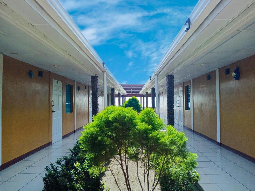 an empty hallway of a building with plants at Miraflores Beach Lodge in Santo Domingo