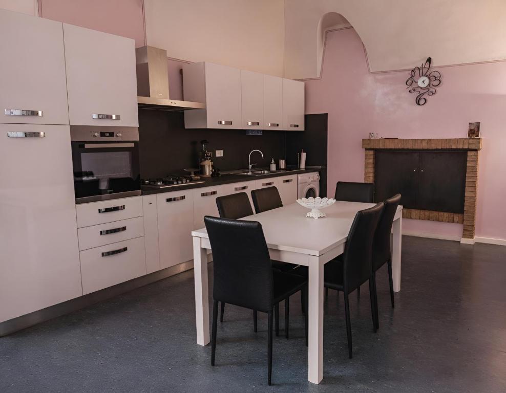 a kitchen with a white table and black chairs at Casa Belvedere - A Due Passi Dal Centro - ItalyWeGo in Narni