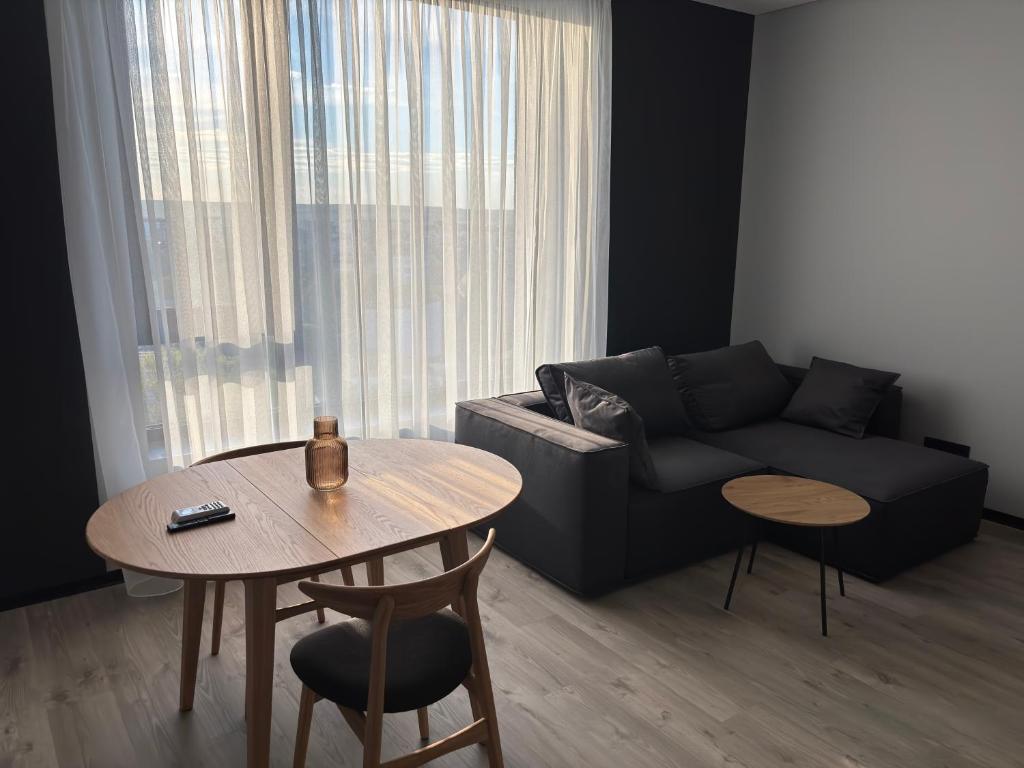 a living room with a couch and a table at Bavaro apartments 5 in Ivano-Frankivsk