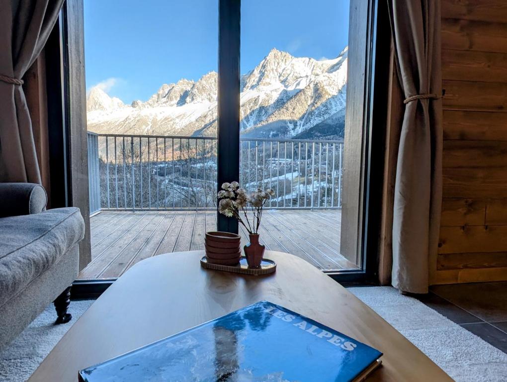 a living room with a table and a view of a mountain at Apartment Leo - 2BR, Modern, Lift access, Mountain views in Les Houches
