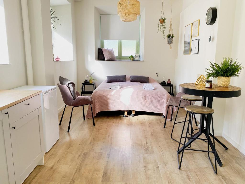 a bedroom with a bed and a table and chairs at Modern Studio 1 in Historic Abbey in Cadier en Keer