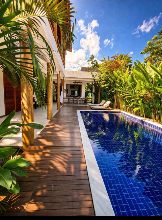 a swimming pool in front of a villa at CASA SIMONI Trancoso in Trancoso