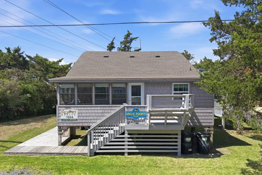a house with a sign on the front of it at 7604 - Uncle Pooh's Cottage in Avon