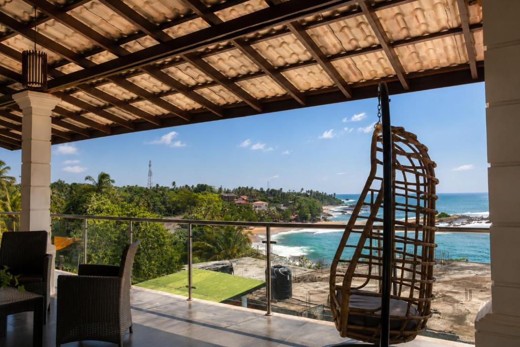 a room with a view of the ocean at Queens Beach Hotel in Tangalle