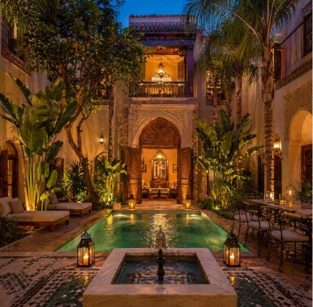 a large house with a swimming pool in a courtyard at l'écrin d'atlas in Yasmine